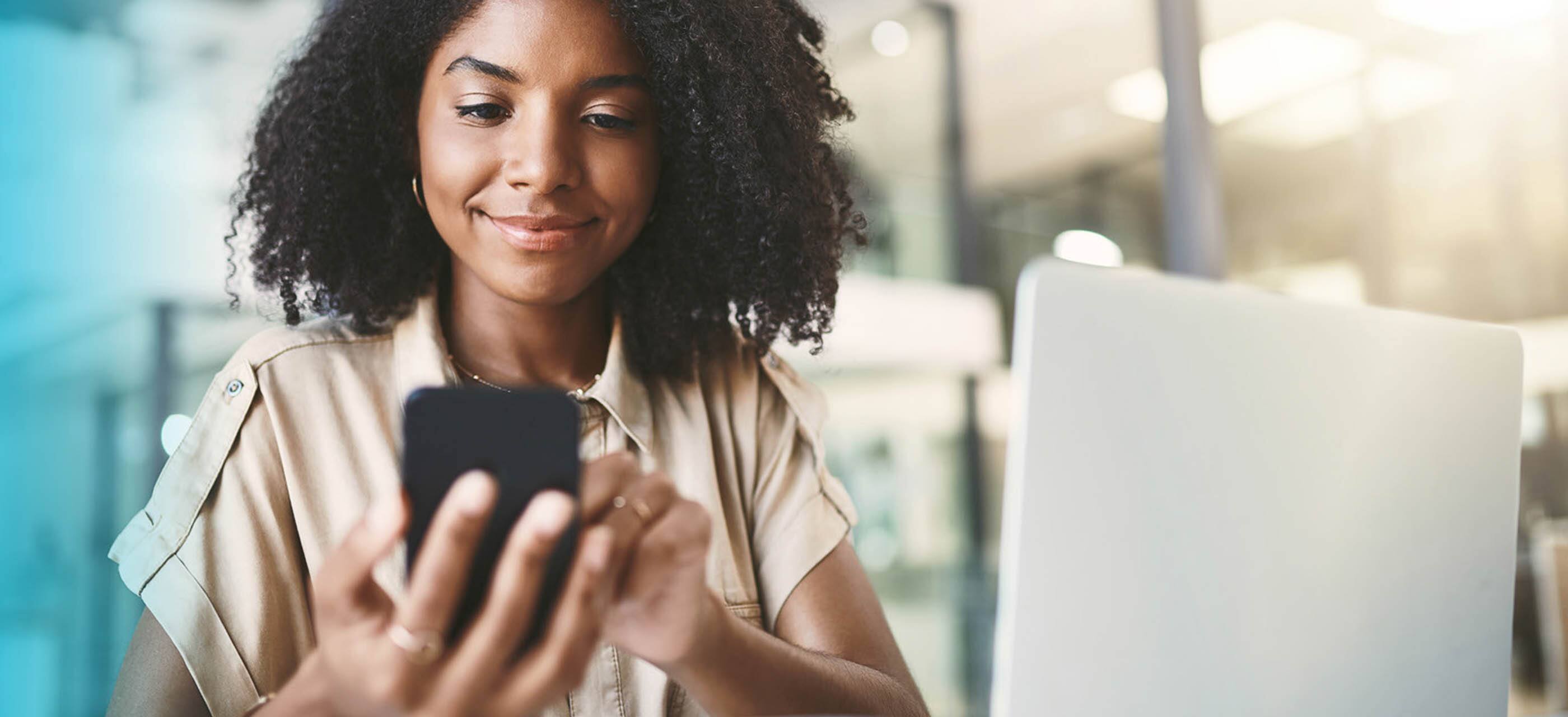 Girl using her smartphone at work