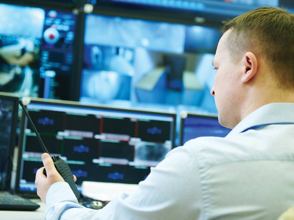 man monitoring video surveillance videos