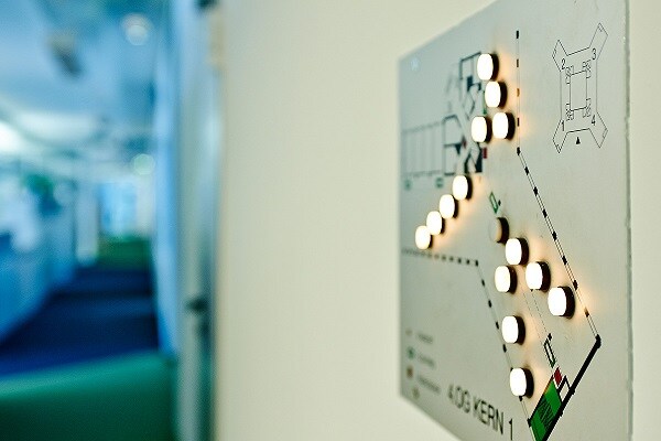 Floor map on a wall with circular lights switched on