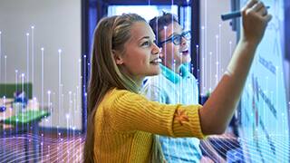 Students writing on smart board